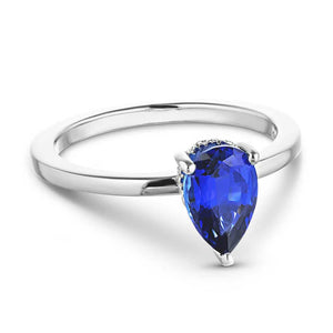 Hidden halo engagement ring with 1ct pear cut lab grown blue sapphire in 14k white gold band