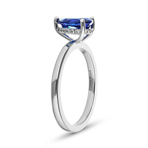 Hidden halo engagement ring with 1ct pear cut lab grown blue sapphire in 14k white gold band shown from side