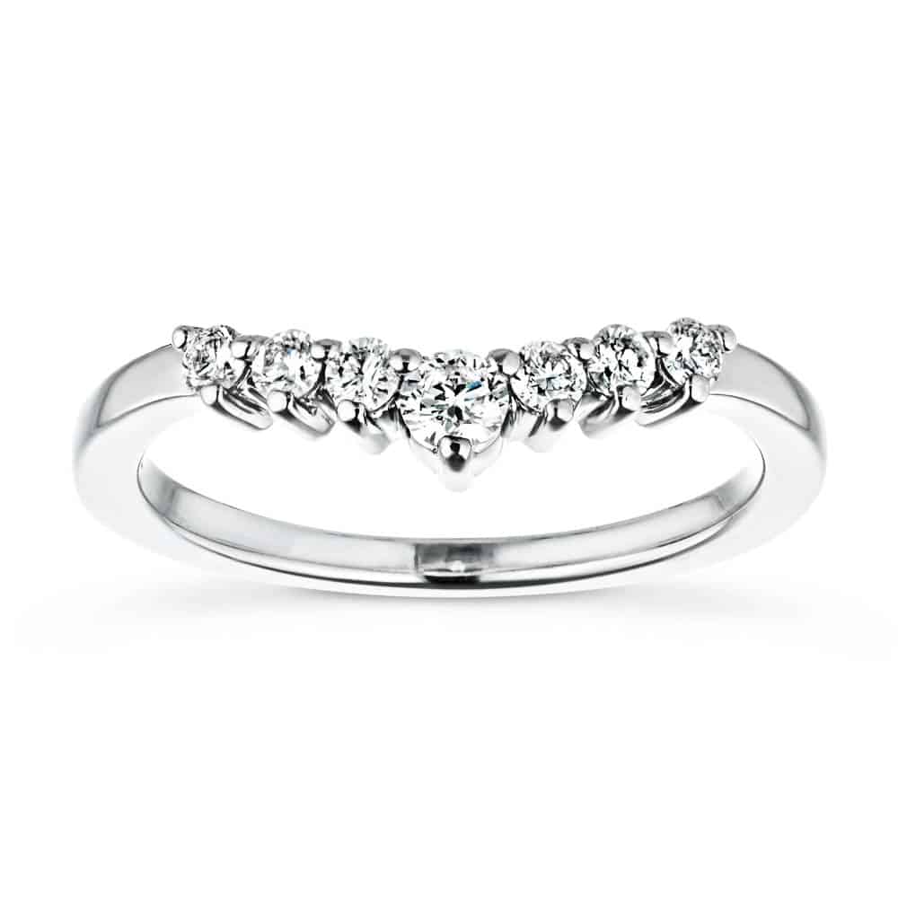 The Cordelia Wedding Band has a .21ctw half halo of round cut recycled diamonds that get larger in size as they meet in the middle of the recycled 14K white gold band 