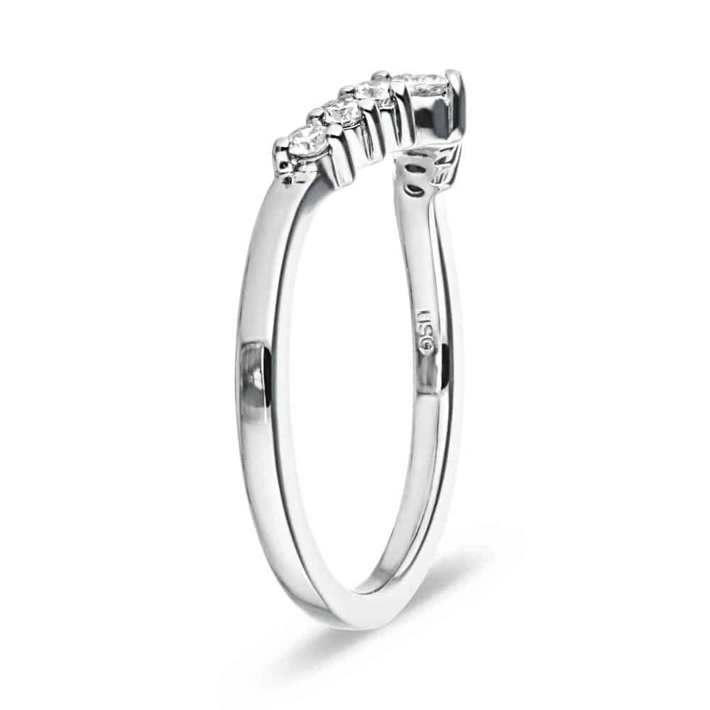 The Cordelia Wedding Band has a .21ctw half halo of round cut recycled diamonds that get larger in size as they meet in the middle of the recycled 14K white gold band 