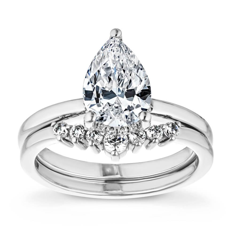 Shown with a 1.0ct Pear cut Lab-Grown Diamond with a hidden halo in recycled 14K white gold with matching wedding band 