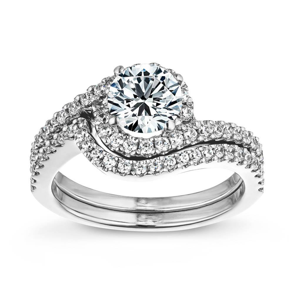 Shown with a 1.0ct Round cut Lab-Grown Diamond with recycled accenting diamond halo and band in recycled 14K white gold with matching band 