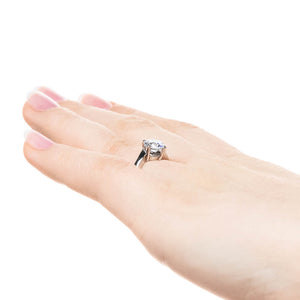Modern simple minimalistic solitaire engagement ring with 1ct round cut lab grown diamond in 14k white gold shown on hand sideview