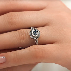 Beautiful unique twisted diamond halo engagement ring with a 1ct round cut lab grown diamond in 14k white gold worn on hand
