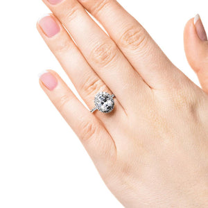 Dream diamond halo engagement ring with diamond accents and a 1ct oval cut lab grown diamond in platinum worn on hand