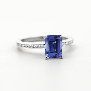 Diamond accented channel set engagement ring with 1ct radiant cut lab grown blue sapphire set in platinum