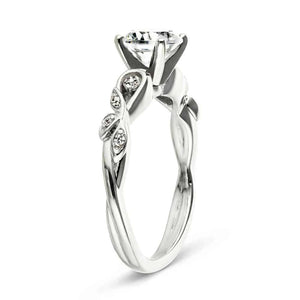 Nature inspired engagement ring with diamond accenting and a 1ct round cut lab grown diamond in 14k white gold shown from side