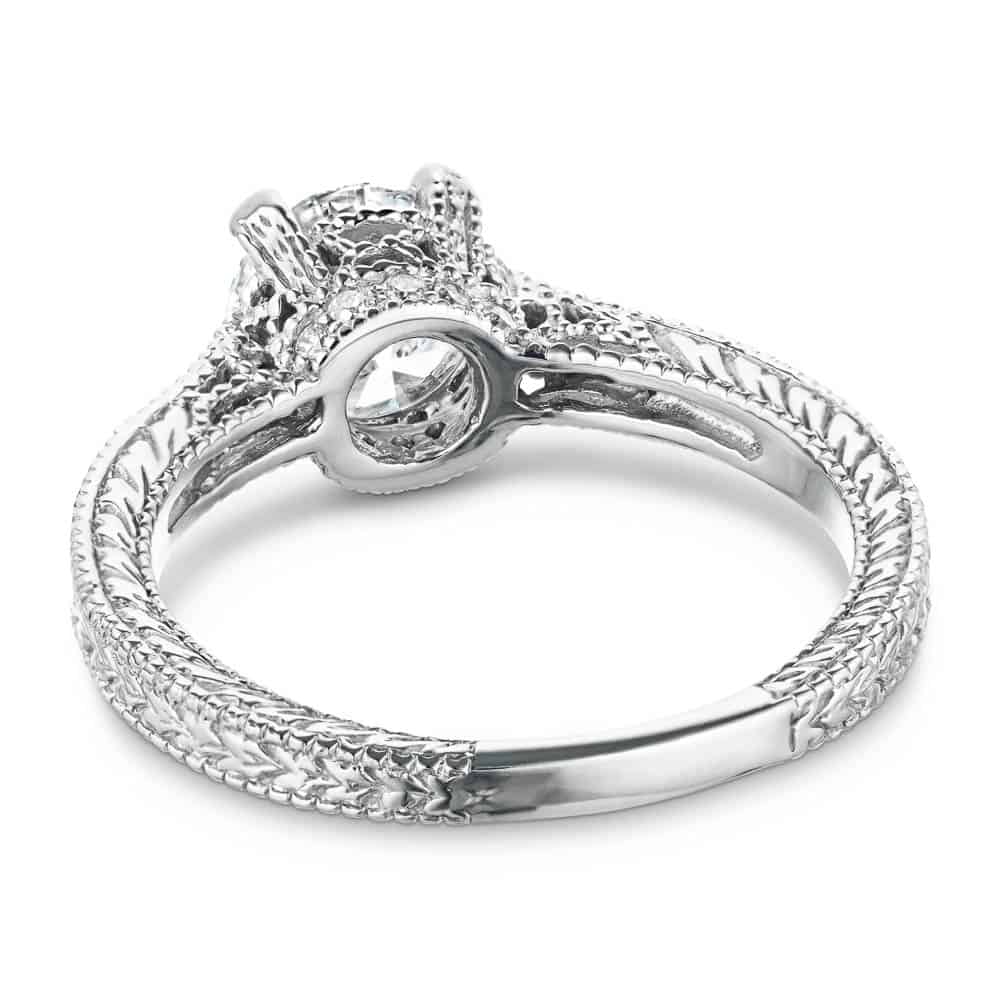 Shown with a 1.25ct Round cut Lab-Grown Diamond with filigree detail and accenting diamonds on the band in recycled 14K white gold  