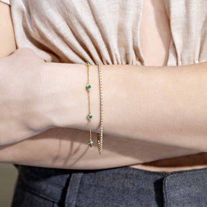 Lab Created Emerald Gemstone in Bezel Station Chain Bracelet in 14 carat yellow gold by MiaDonna shown worn on woman's wrist