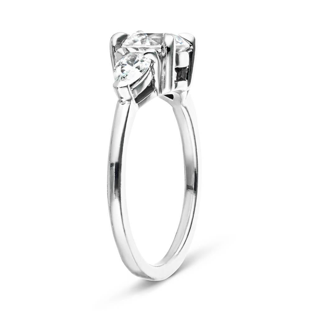 Shown with 1ct Round Cut Lab Grown Diamond Center Stone in 14k White Gold|Three stone engagement ring with 1ct round cut lab grown diamond center and 0.5ct pear cut diamond side stones in 14k white gold