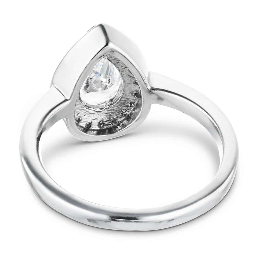 Shown here with a 1.3ct pear lab-grown diamond in recycled 14K white gold. | Lab-grown diamond halo white gold wedding set.