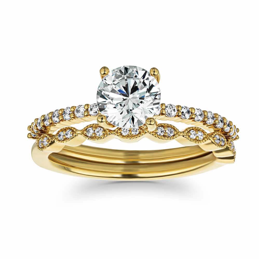 Set shown with a 1ct Round cut Lab Grown Diamond in 14k Yellow Gold|Diamond accented vintage style wedding ring set featuring 14k yellow gold engagement ring with 1ct round cut lab grown diamond
