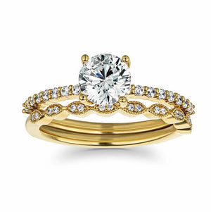 Diamond accented vintage style wedding ring set featuring 14k yellow gold engagement ring with 1ct round cut lab grown diamond