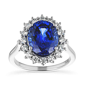 Vintage style engagement ring with floral design halo around a 3ct lab created blue sapphire in 14k white gold
