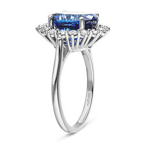 Vintage style engagement ring with floral design halo around a 3ct lab created blue sapphire in 14k white gold shown from side