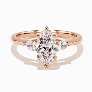 three stone engagement ring with marquise shape lab grown diamond center stone in 14k rose gold 