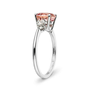 Three stone engagement ring with 2ct lab created champagne pink sapphire center stone and pear diamond side stones in 14k white gold shown from side