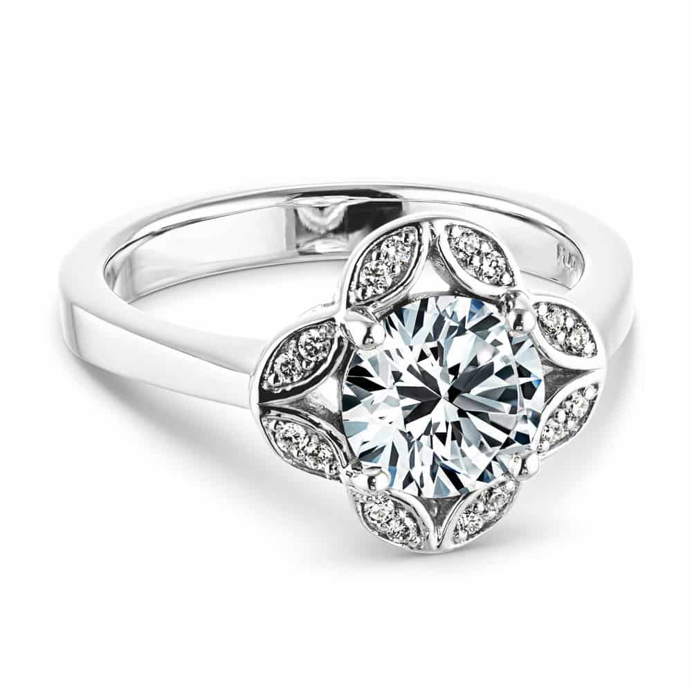 Shown with 1ct round cut lab grown diamond in 14k white gold|Nature inspired vintage style engagement ring with floral petal halo design around a 1ct round cut lab diamond in 14k white gold