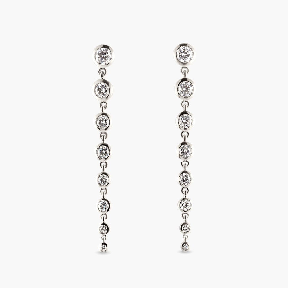 Graduated Lab Grown Diamond Bezel Drop earrings containing 1.75ctw of VS clarity F colored Diamonds in 14k White Gold