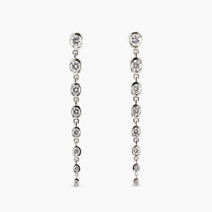 Graduated Lab Grown Diamond Bezel Drop earrings containing 1.75ctw of VS clarity F colored Diamonds in 14k White Gold