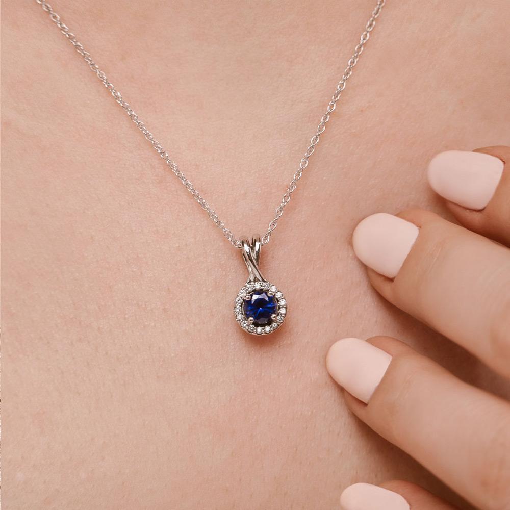 Set with a 1.7ct round lab-grown blue sapphire 