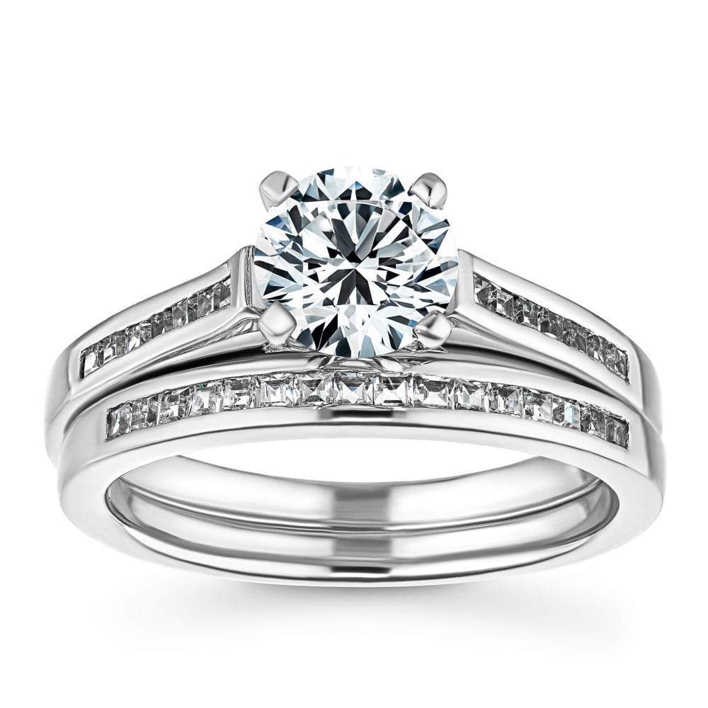 Shown with a 1.0ct Round cut Lab Grown Diamond with channel set diamond accented band with matching wedding band in recycled 14K white gold | wedding set Shown with a 1.0ct Round cut Lab Grown Diamond with channel set diamond accented band with matching wedding band in recycled 14K white gold