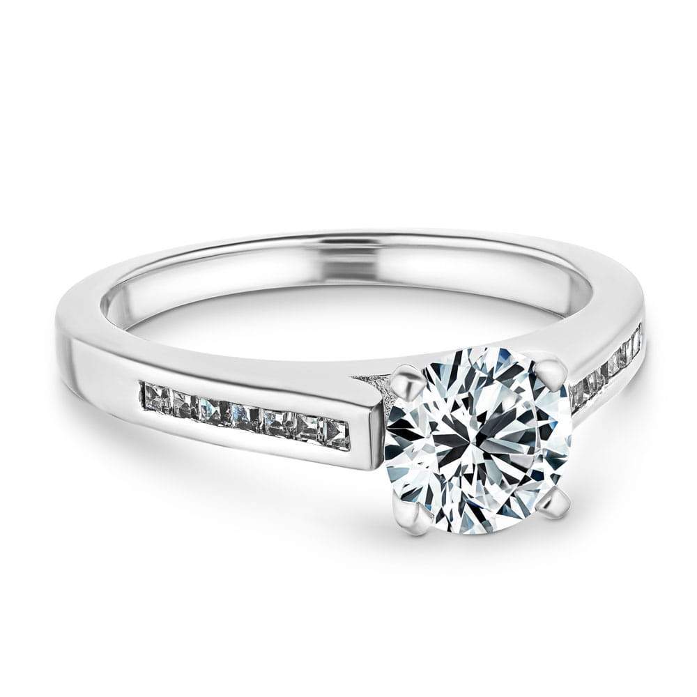Shown with a 1.0ct Round cut Lab Grown Diamond with channel set diamond accented band in recycled 14K white gold 