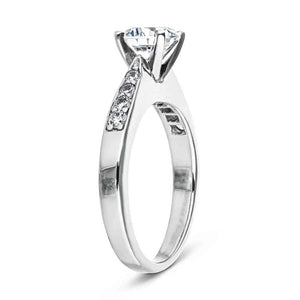 Modern channel set diamond engagement ring in white gold shown from side