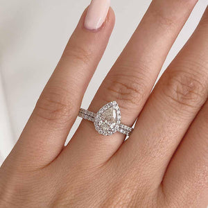  halo diamond accented engagement ring Shown with a 1.20ct Pear cut Lab-Grown Diamond with a diamond accented halo and band in recycled 14K white gold with matching wedding band