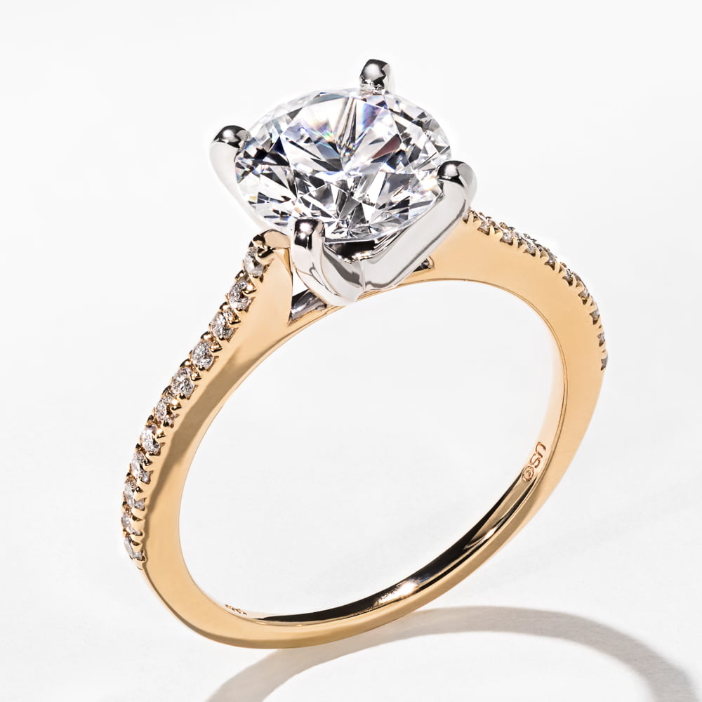 Shown with 1.5ct Round Cut Lab-Grown Diamond in 14k Yellow Gold with a White Gold Prong Head