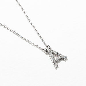 diamond and gold initial necklace.