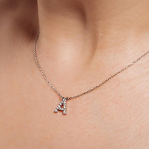 diamond and gold initial necklace.