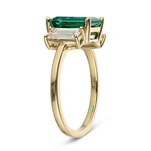 Three stone basket set engagement ring with green emerald and yellow gold shown from side