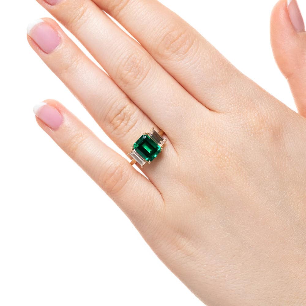 Shown with 2ct Emerald Cut Lab Grown Emerald with 2 Baguette Cut Lab Diamonds in 14k Yellow Gold
