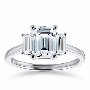 Beautiful three stone engagement ring with 1.75ct emerald cut lab grown diamond center stone and two baguette cut diamond side stones in 14k white gold
