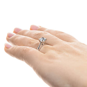 Solitaire engagement ring with 1ct round cut lab grown diamond in a 4 prong 14k white gold setting worn on hand sideview