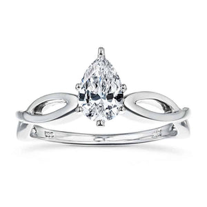 Modern solitaire engagement ring with a 1ct pear cut lab grown diamond in twisted metal design 16k white gold band