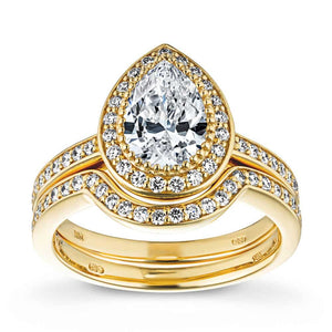  french engagement ring Shown with a 1.0ct Pear cut Lab-Grown Diamond with a diamond accented halo and band in recycled 14K yellow gold matching wedding band