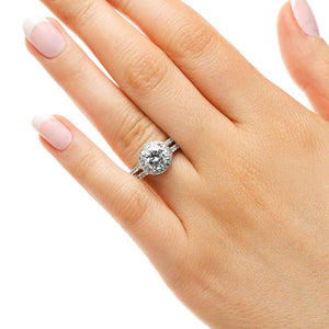 Diamond accented split shank halo engagement ring with 1.5ct round cut lab grown diamond in 14k white gold worn on hand