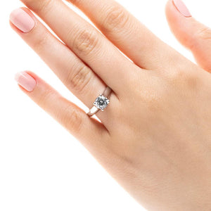 Simple trellis style solitaire engagement ring with 1ct round cut lab grown diamond in 14k white gold worn on hand