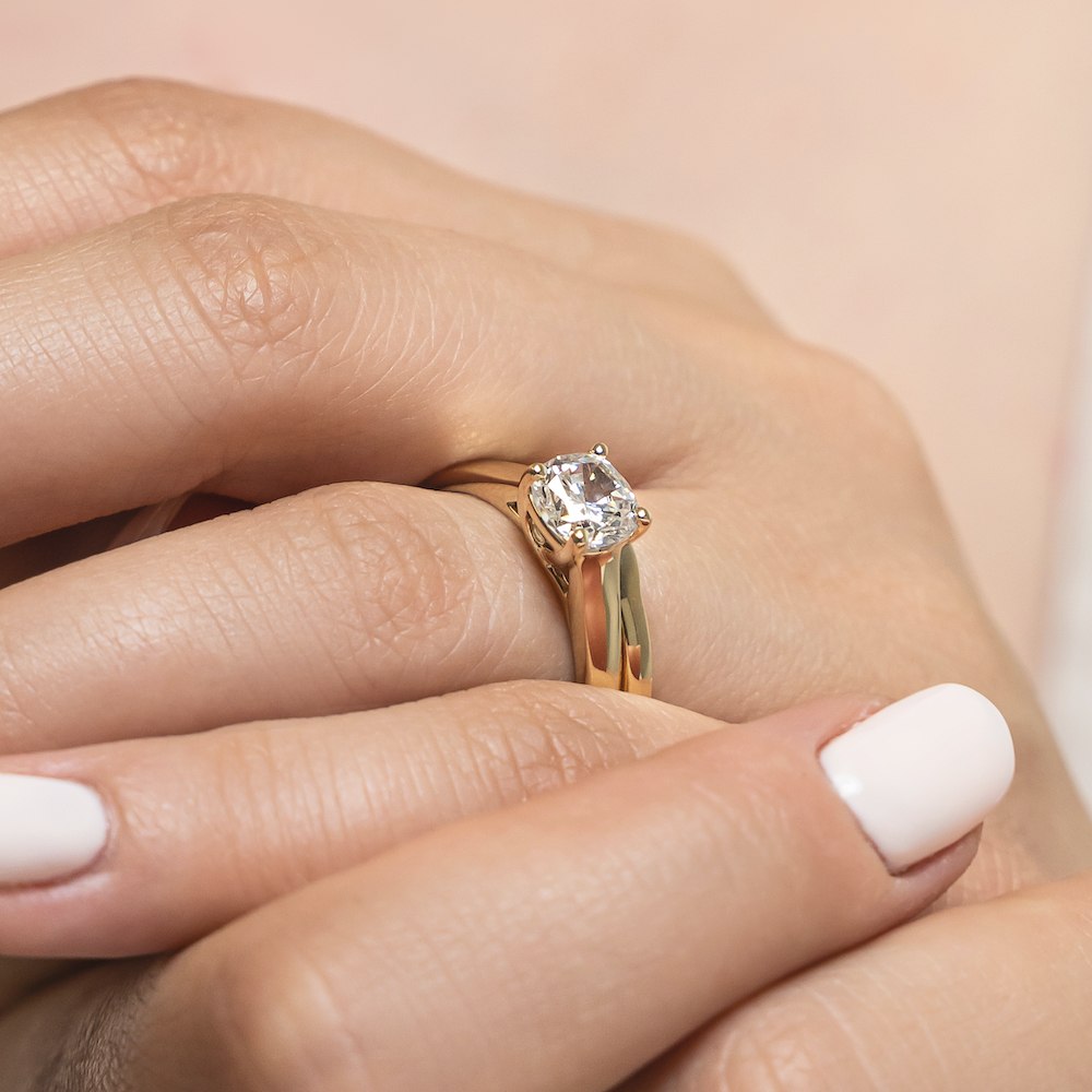 Shown with a 1.0ct Round cut Lab-Grown Diamond in recycled 14K yellow gold with matching wedding band 