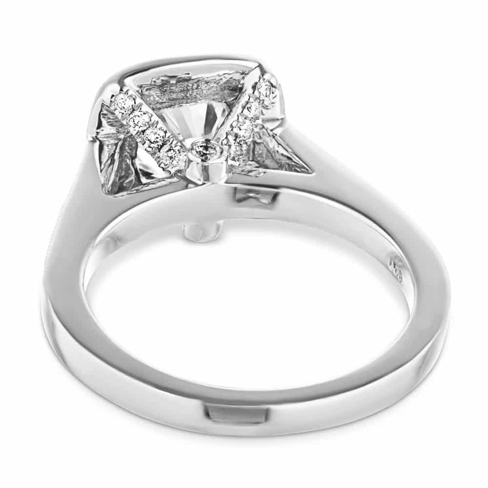 Shown with a 1.0ct Cushion cut Lab-Grown Diamond with a diamond accented and filigree detailed halo and accenting diamonds on the band in recycled 14K white gold 