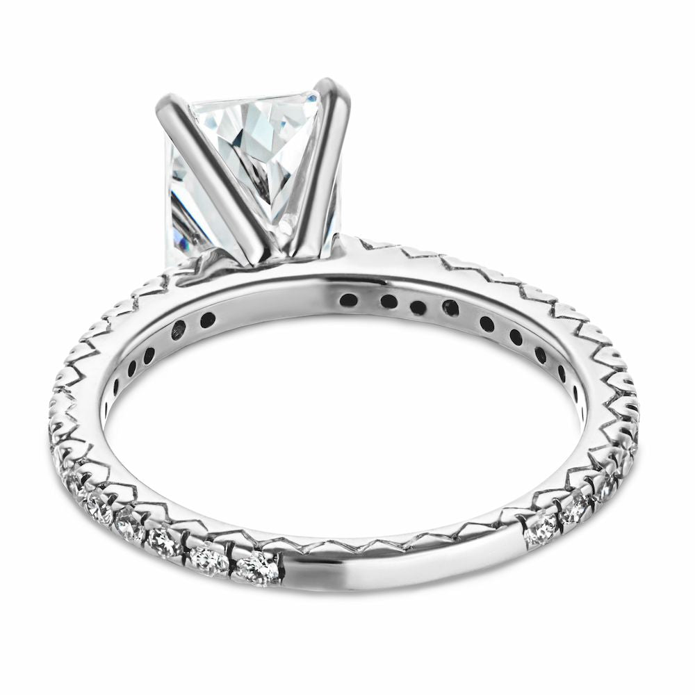 Shown with a 1.0ct radiant cut Lab-Grown Diamond with recycled diamonds that go approximately 3/4 around the slightly squared band in recycled 14K white gold 