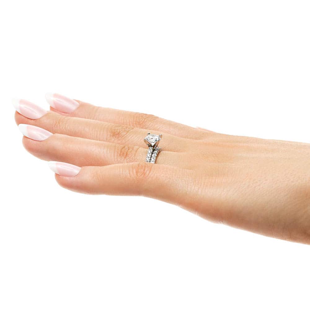 Shown with a 1.0ct Round cut Lab-Grown Diamond with an eternity style diamond band in recycled 14K white gold, can be purchased as a set for a discount