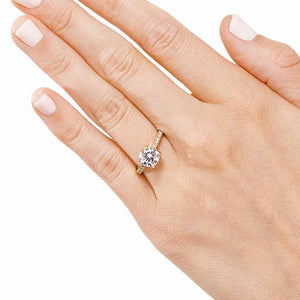 Diamond accented solitaire engagement ring with 1ct round cut lab grown diamond in 14k yellow gold worn on hand