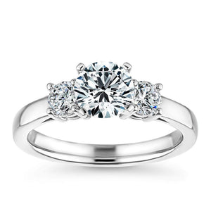 Beautiful ethical three stone engagement ring with 4 prong set 1ct round cut lab grown diamond and two 0.5ct side stones in 14k white gold