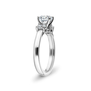 Three stone engagement ring with prong and basket set round lab diamonds in 14k white gold shown from side