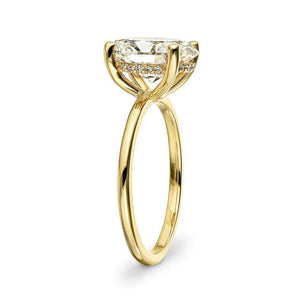 Hidden halo engagement ring with 4 prong set 3ct oval cut lab grown diamond in a thin 14k yellow gold band shown from side