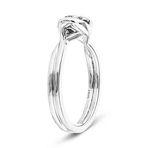 Modern engagement ring with twisted band design holding a 1ct round cut lab grown diamond in platinum setting shown from side