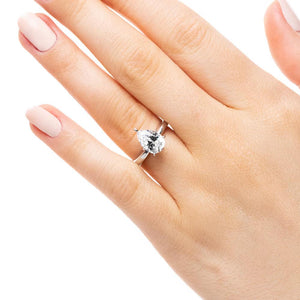 Solitaire engagement ring with 6 prong set 1ct pear cut lab grown diamond in 14k white gold band worn on hand